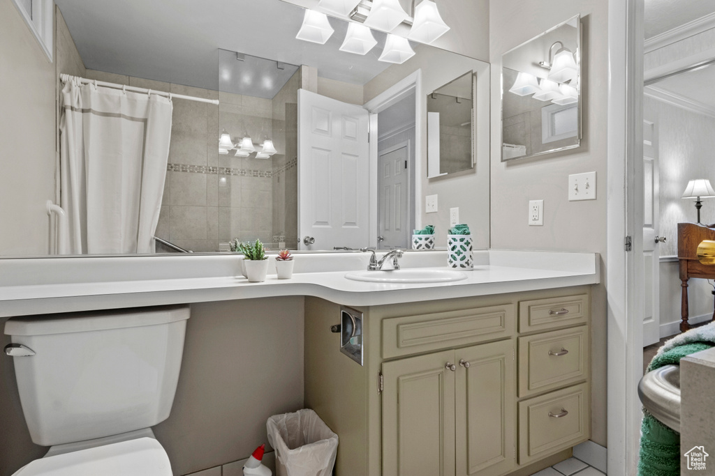 Full bathroom featuring toilet, tiled shower, and vanity