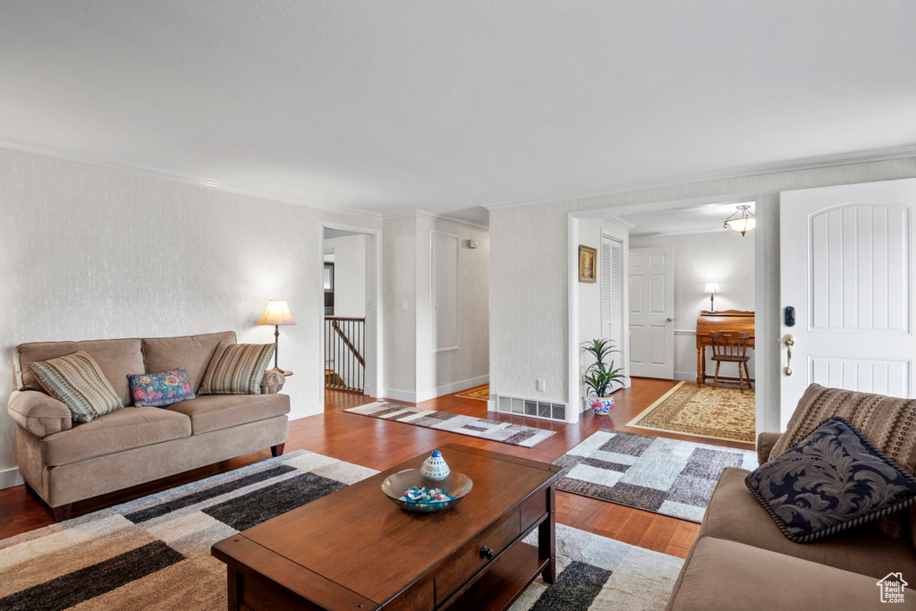 Living area featuring ornamental molding, wood finished floors, and baseboards