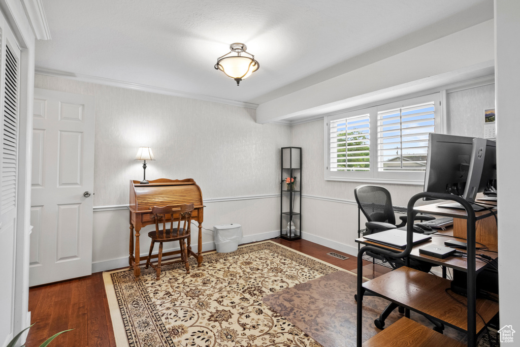 Office area with wood finished floors and crown molding