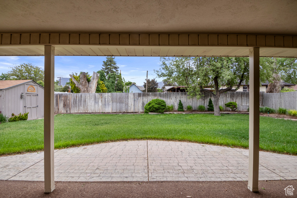 View of patio / terrace with a storage shed and an outbuilding