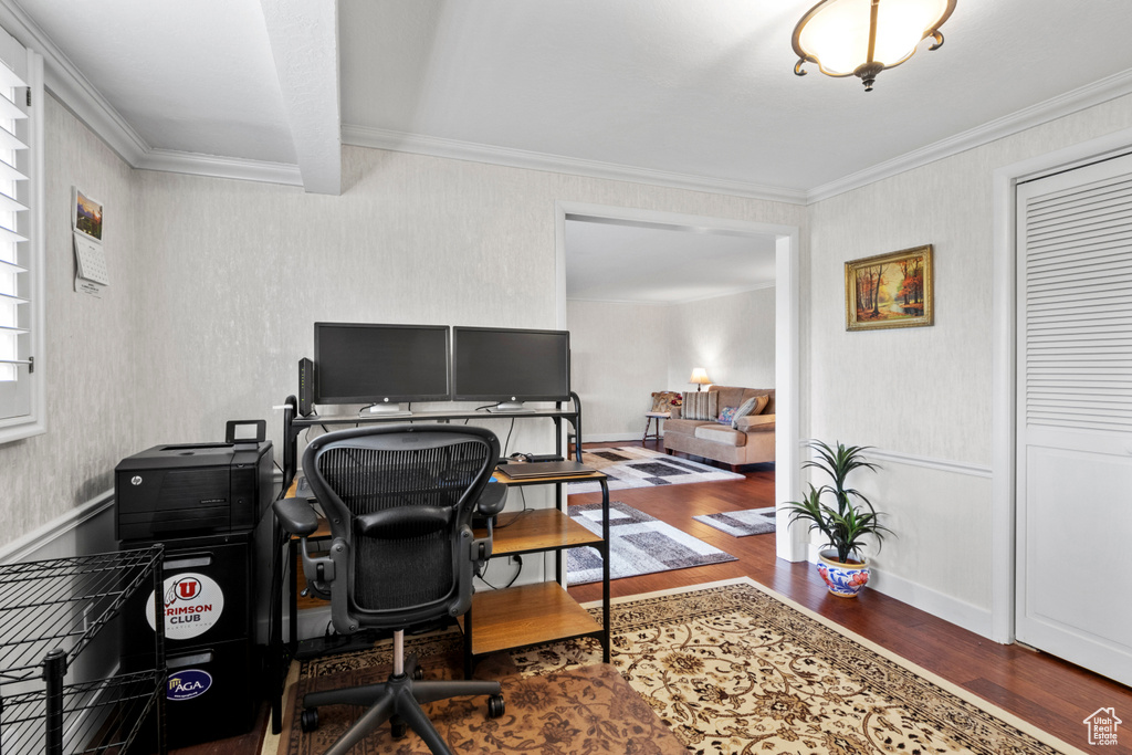 Home office with wood finished floors, ornamental molding, and beam ceiling