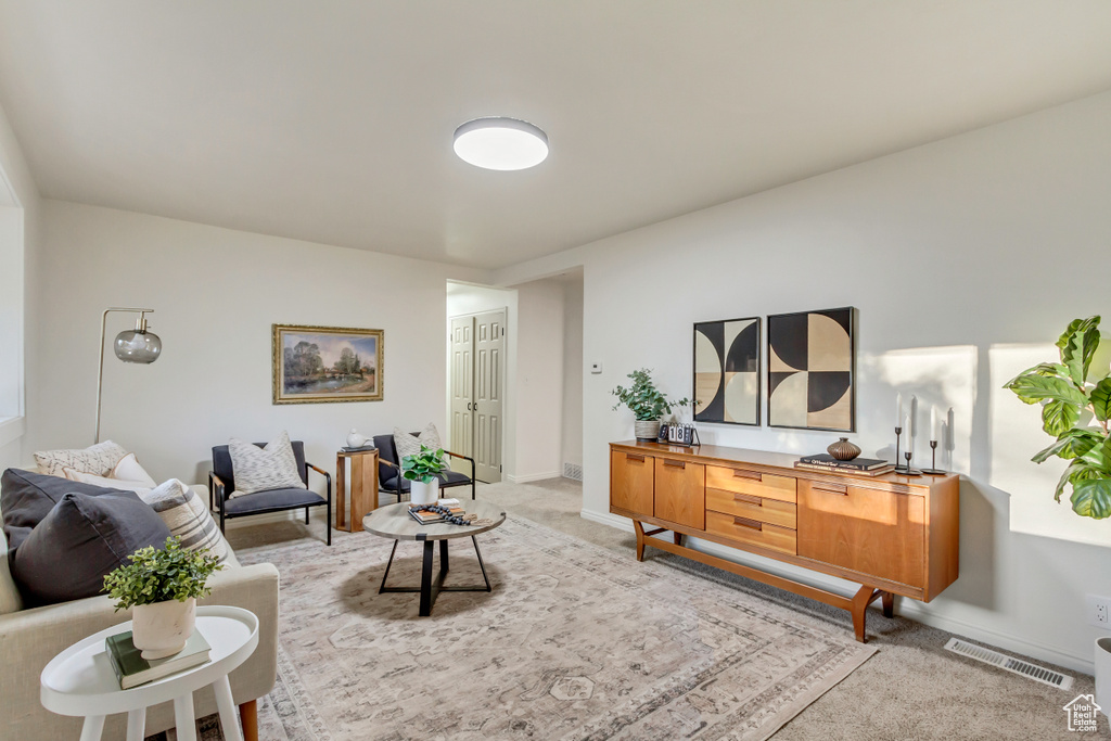 Carpeted living room featuring baseboards