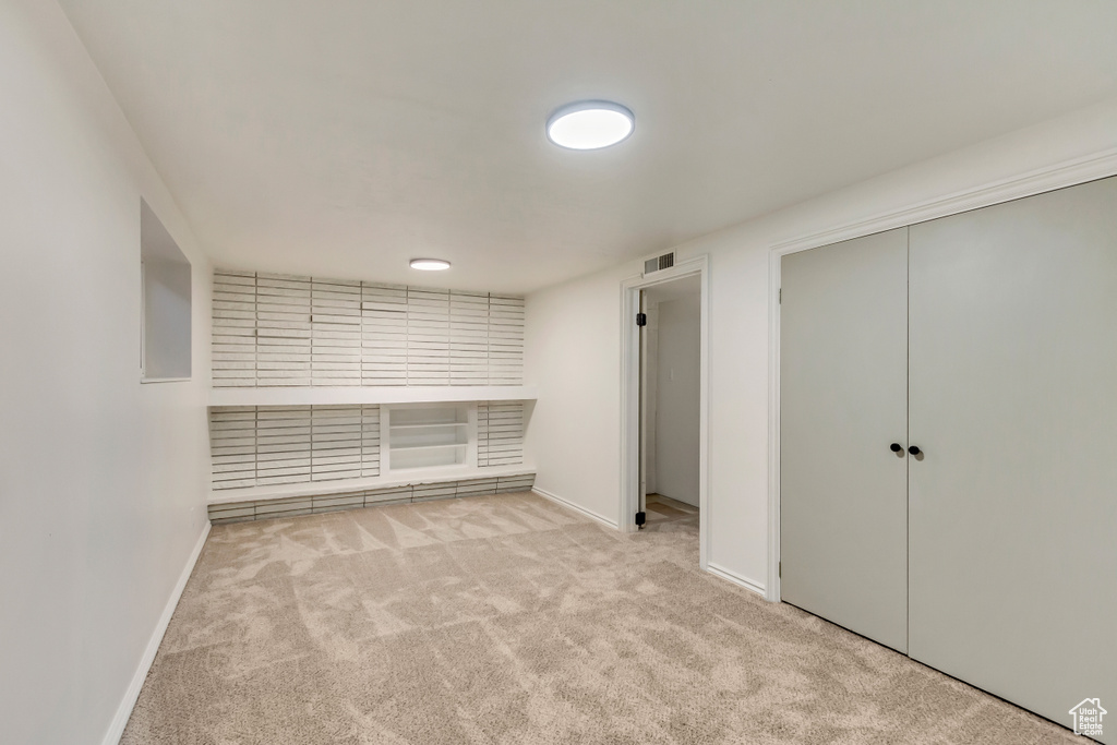 Unfurnished bedroom with carpet, baseboards, and a closet