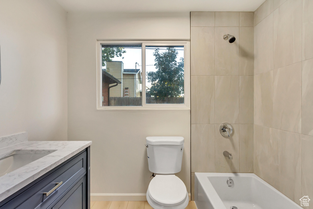 Full bathroom with vanity, washtub / shower combination, and toilet