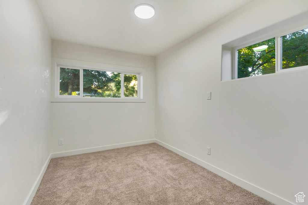 Empty room with carpet floors and baseboards