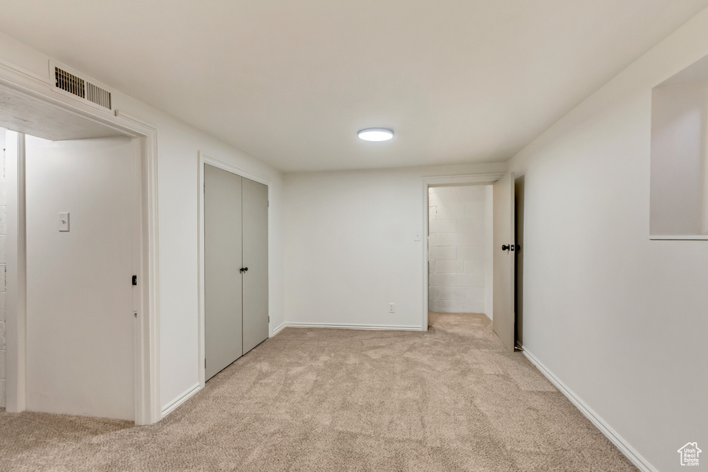 Unfurnished bedroom featuring light carpet