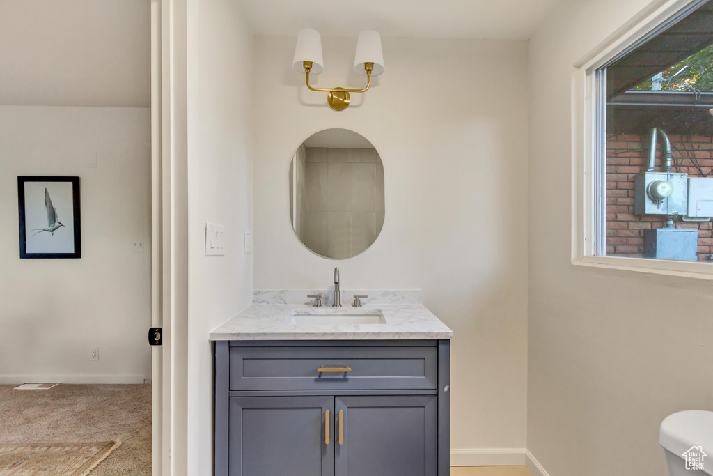 Bathroom with vanity and baseboards