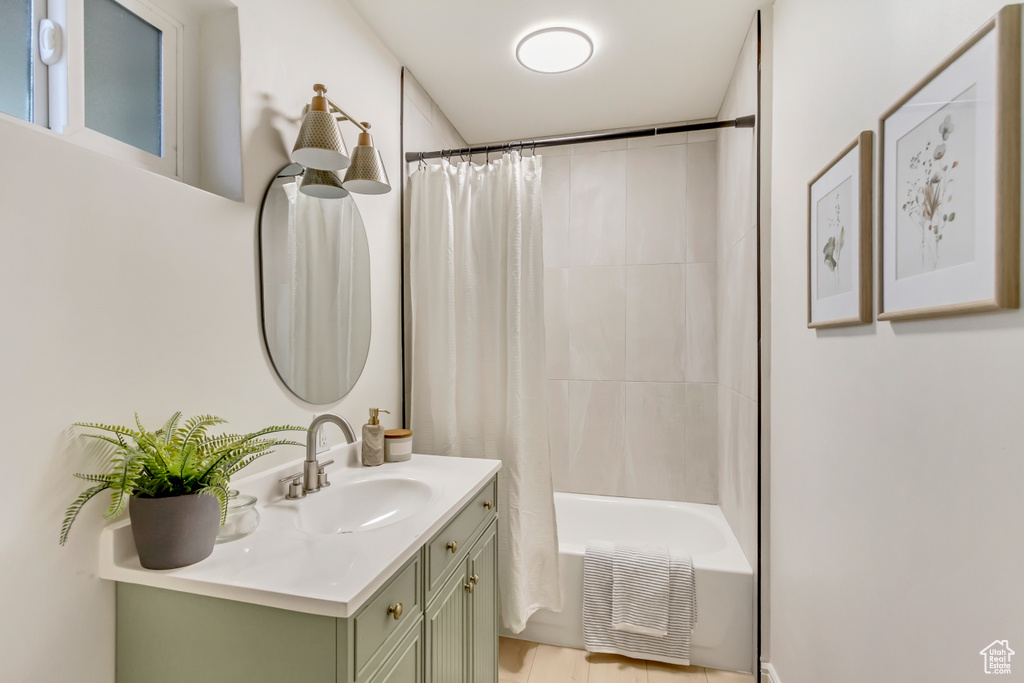 Bathroom with vanity and shower / bath combination with curtain