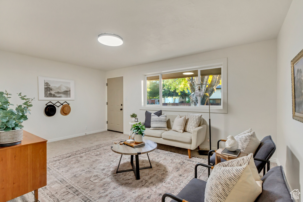 Carpeted living room featuring baseboards