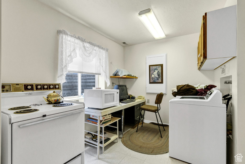 Washroom with washer / dryer and a desk