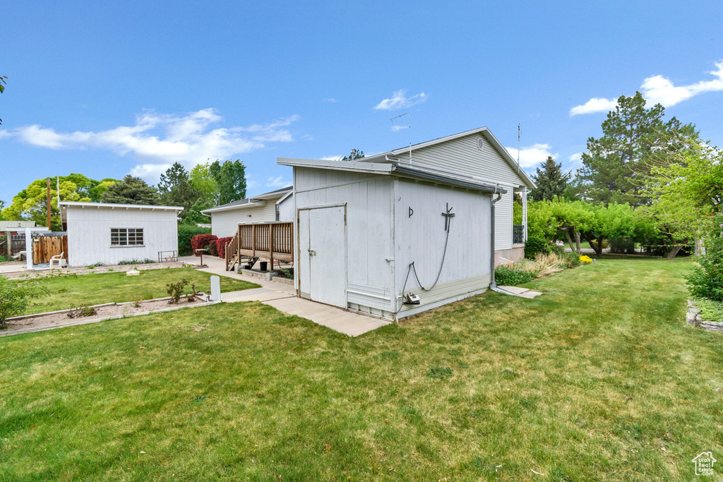 View of yard featuring an outdoor structure and a patio area