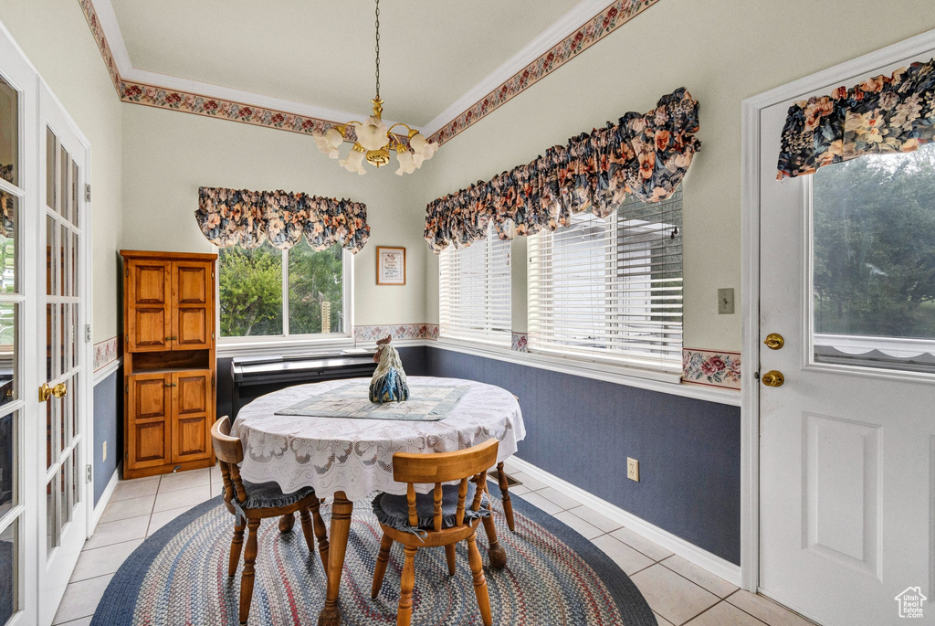 Dining room with a chandelier and light tile patterned floors