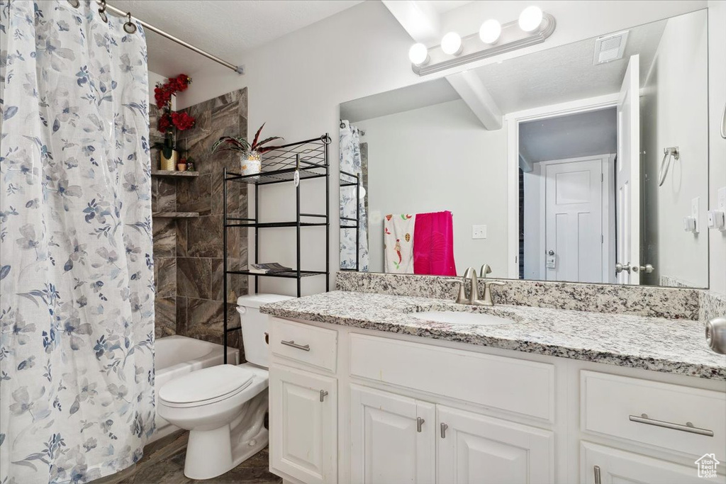 Bathroom featuring toilet, shower / bath combination with curtain, vanity, and wood finished floors