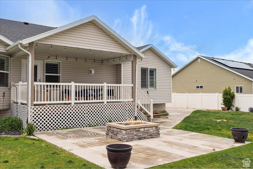 Back of property featuring a patio and a shingled roof