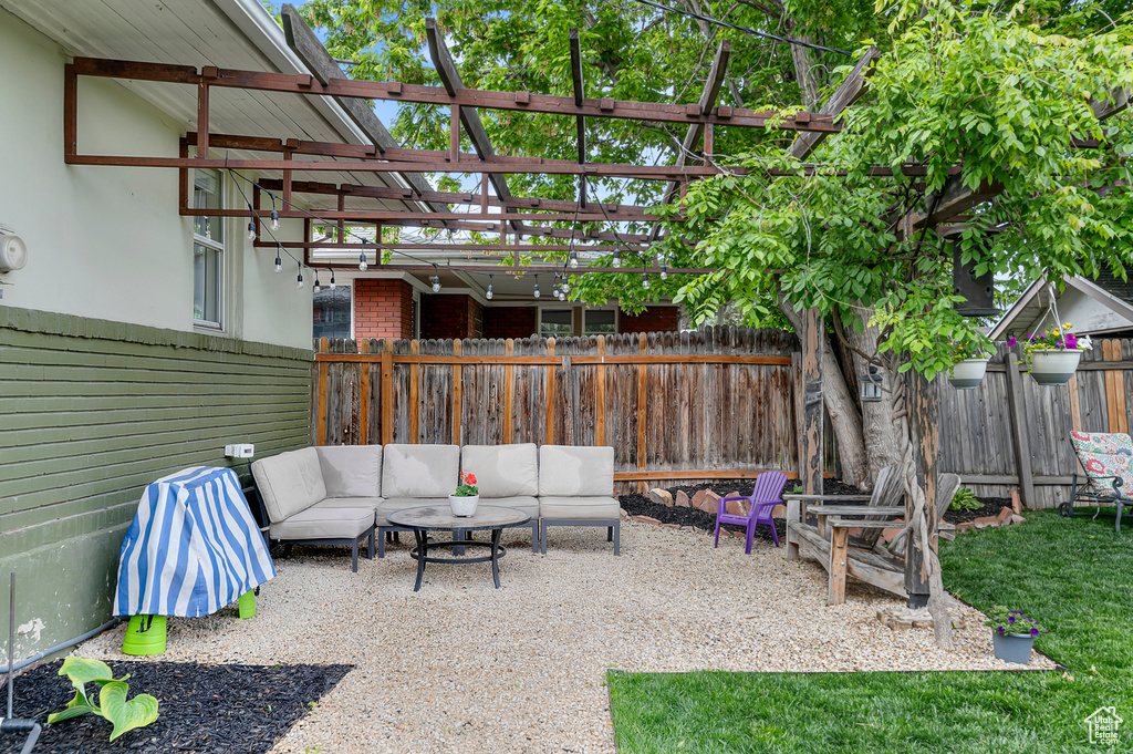 View of patio / terrace featuring a fenced backyard, an outdoor hangout area, and a pergola