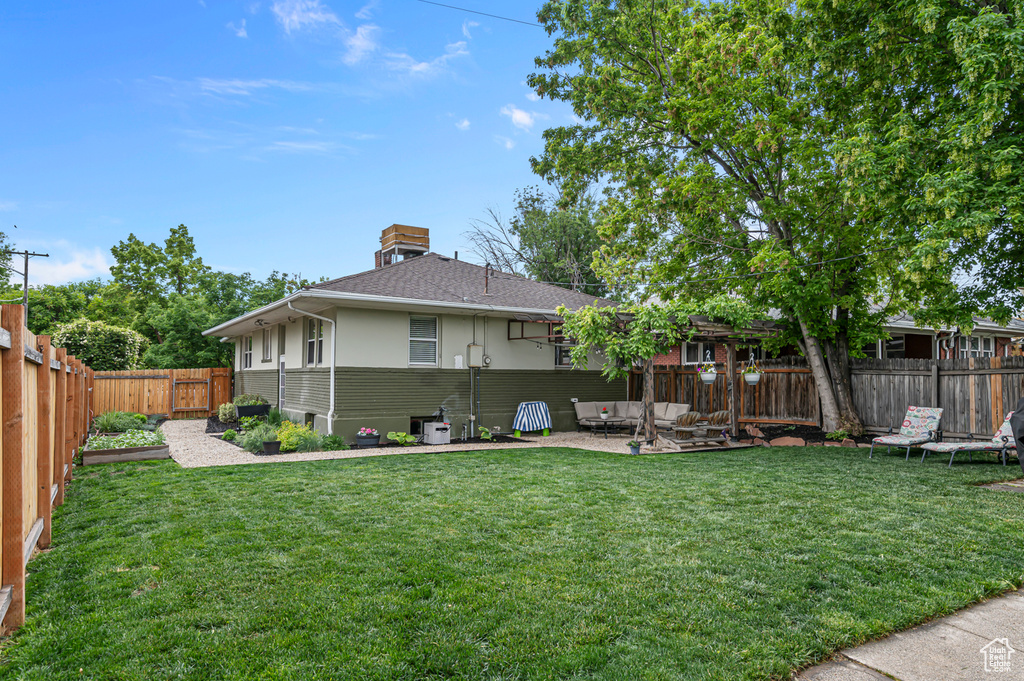 Back of property with a patio area, a shingled roof, stucco siding, and a chimney