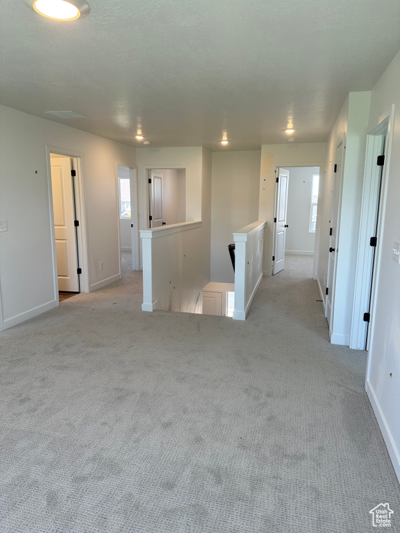Empty room with carpet flooring and baseboards
