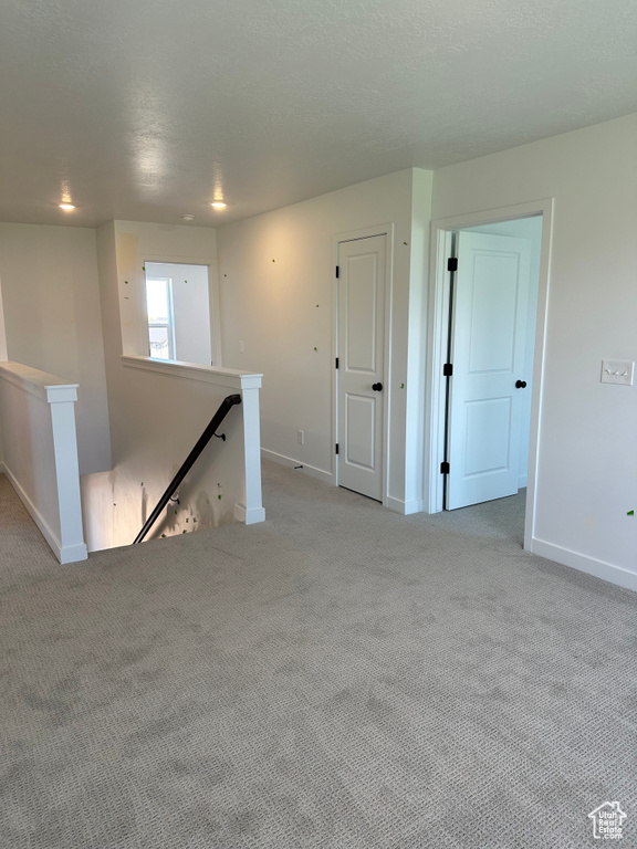 Spare room with light carpet and baseboards