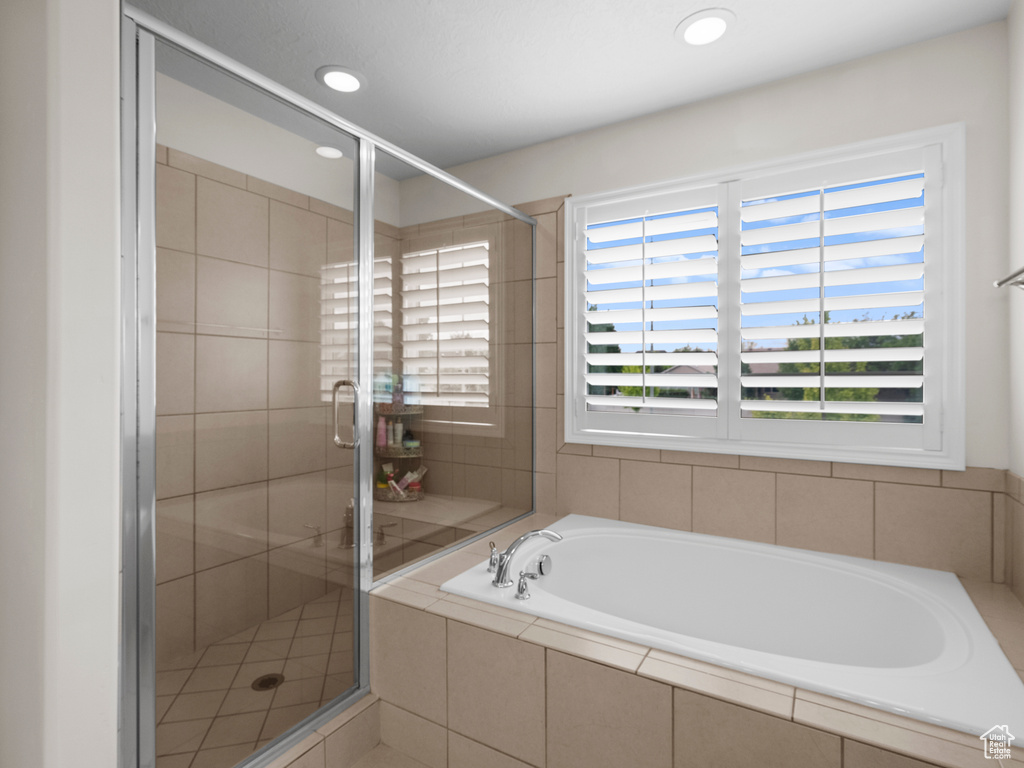 Bathroom featuring a garden tub, a stall shower, and recessed lighting