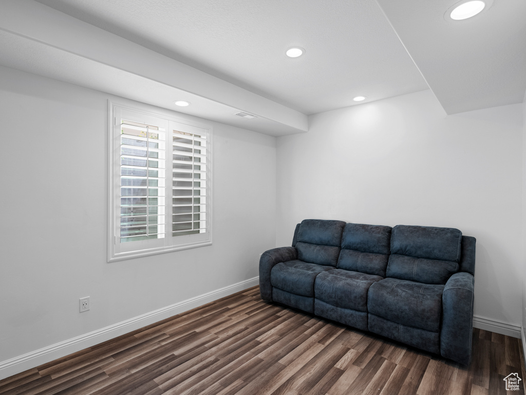 Sitting room with dark wood-style flooring, baseboards, and recessed lighting