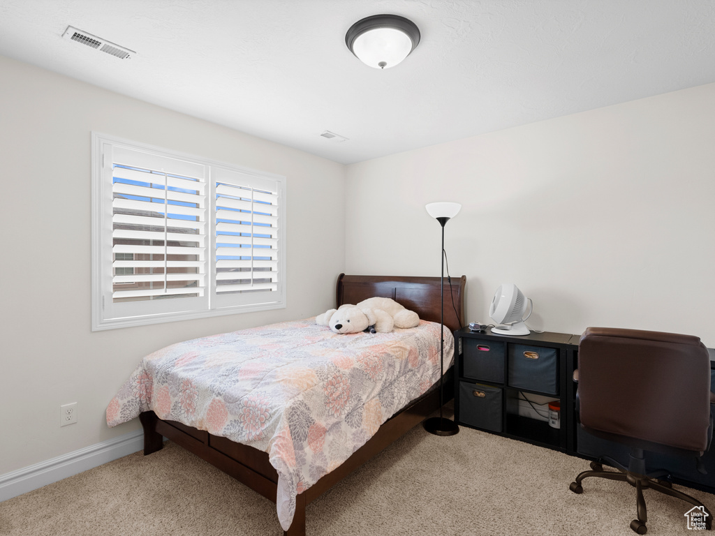 Bedroom with carpet, a desk, and baseboards