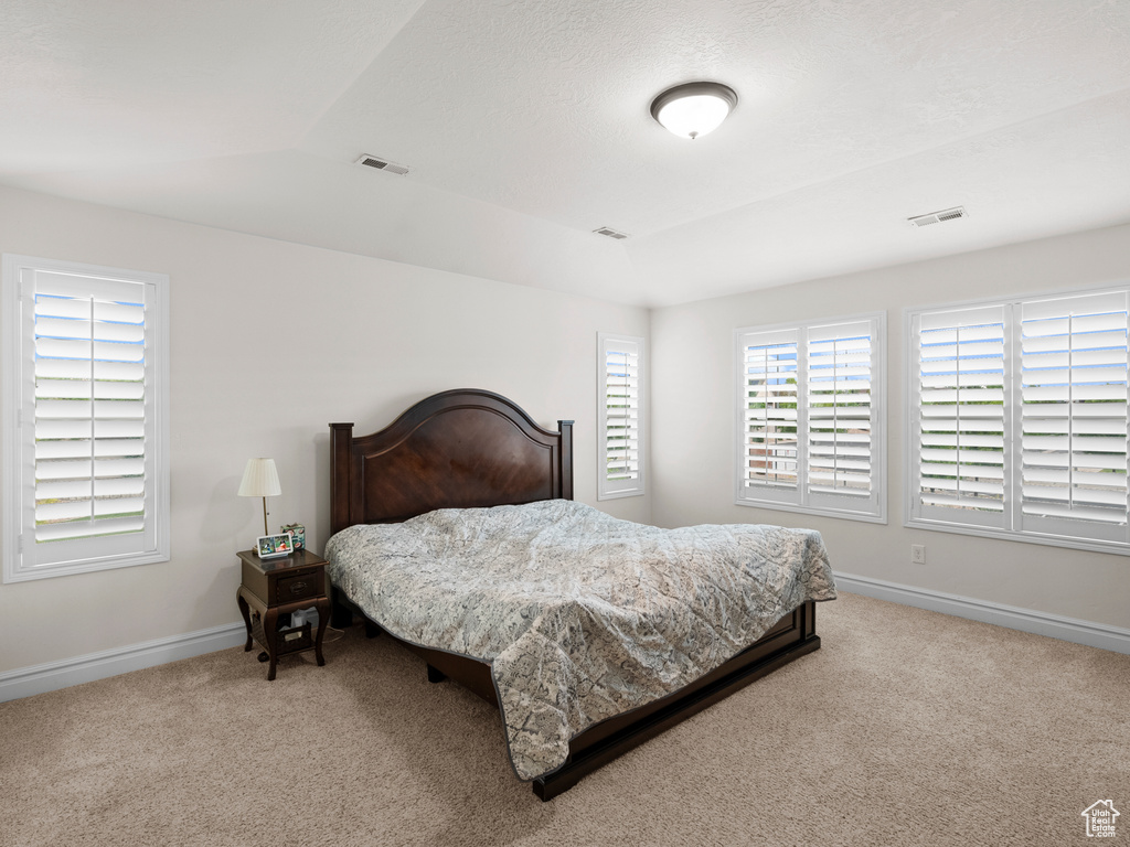 Bedroom featuring carpet flooring and baseboards