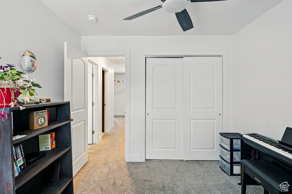 Office area with carpet flooring and ceiling fan