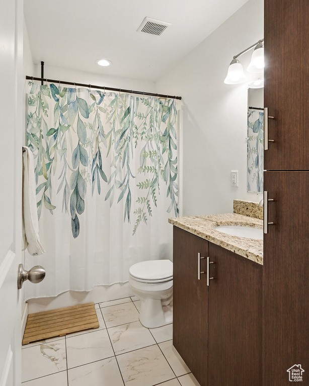 Bathroom featuring marble look tile flooring, toilet, shower / tub combo with curtain, vanity, and recessed lighting