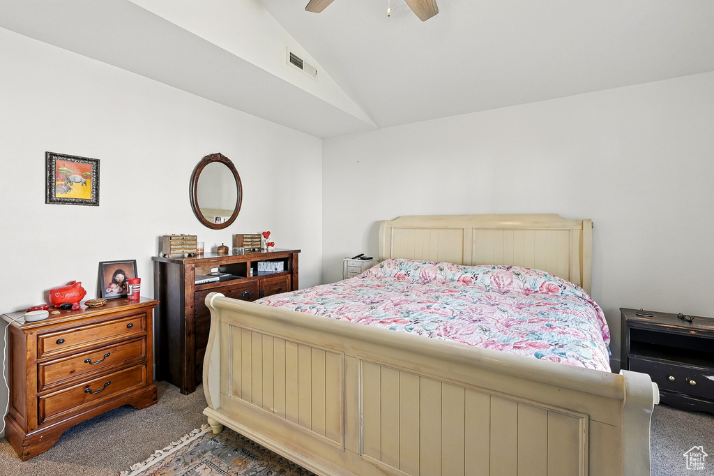 Bedroom featuring carpet flooring, lofted ceiling, and a ceiling fan