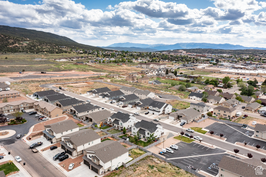 Aerial view of property's location with a mountain backdrop and nearby suburban area