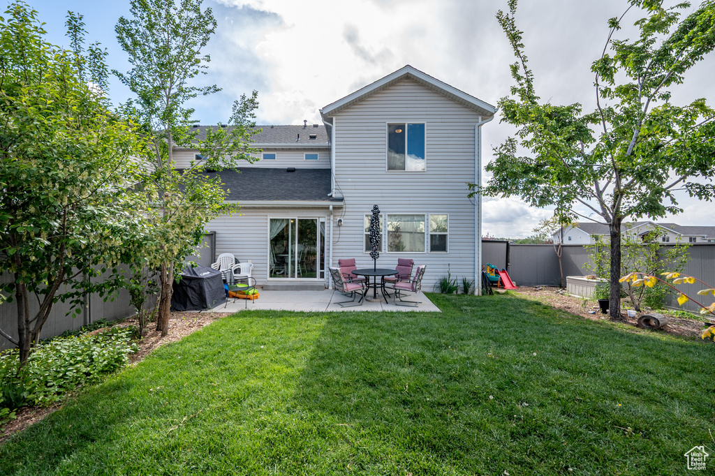 Back of house with a patio
