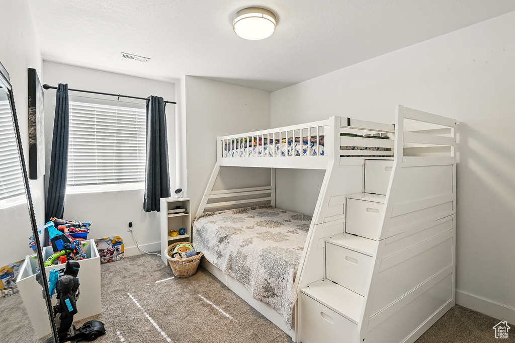 Bedroom featuring carpet and baseboards