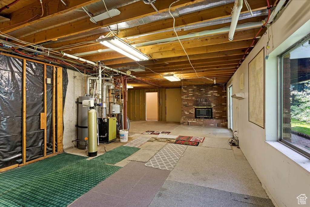 Basement with a fireplace and a heating unit