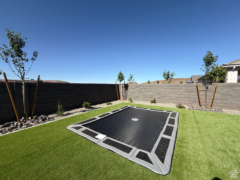 View of yard with a trampoline