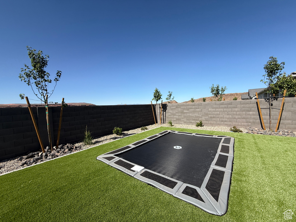 View of yard with a trampoline