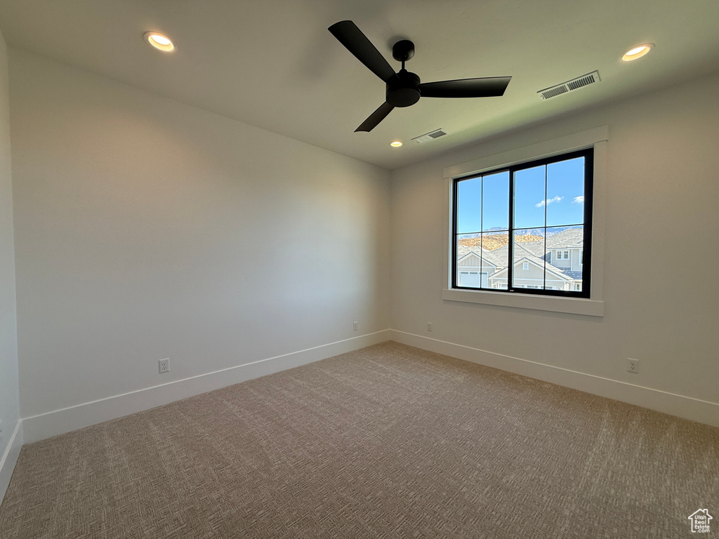 Spare room with ceiling fan, light colored carpet, baseboards, and recessed lighting