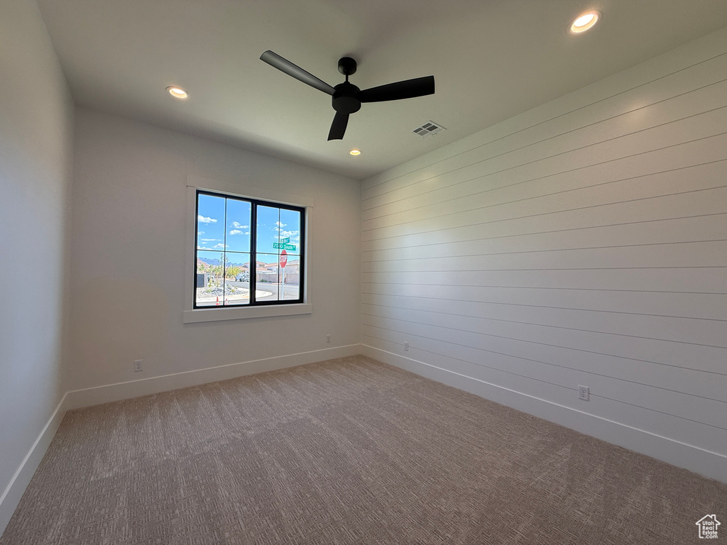 Carpeted spare room with a ceiling fan, recessed lighting, and baseboards