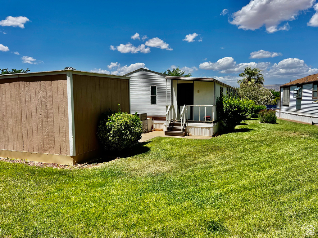 Rear view of house featuring a lawn