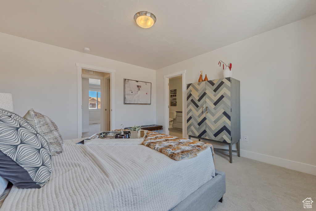 Bedroom with light carpet and baseboards