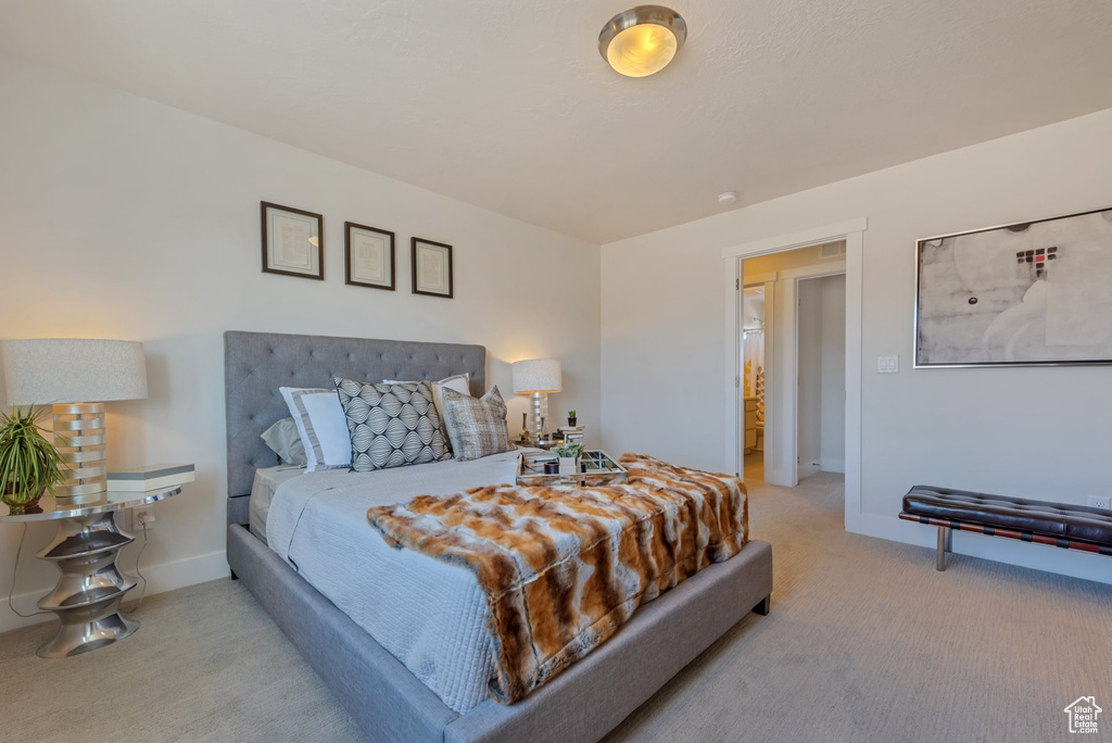 Bedroom featuring light colored carpet and baseboards