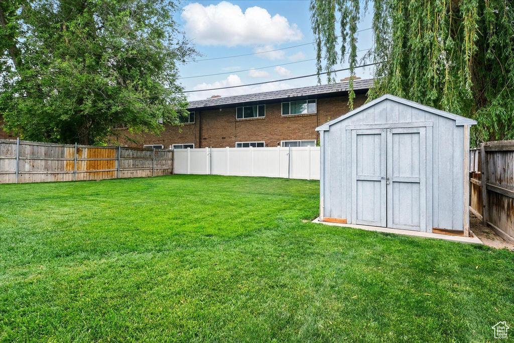 View of yard featuring a storage shed and an outdoor structure