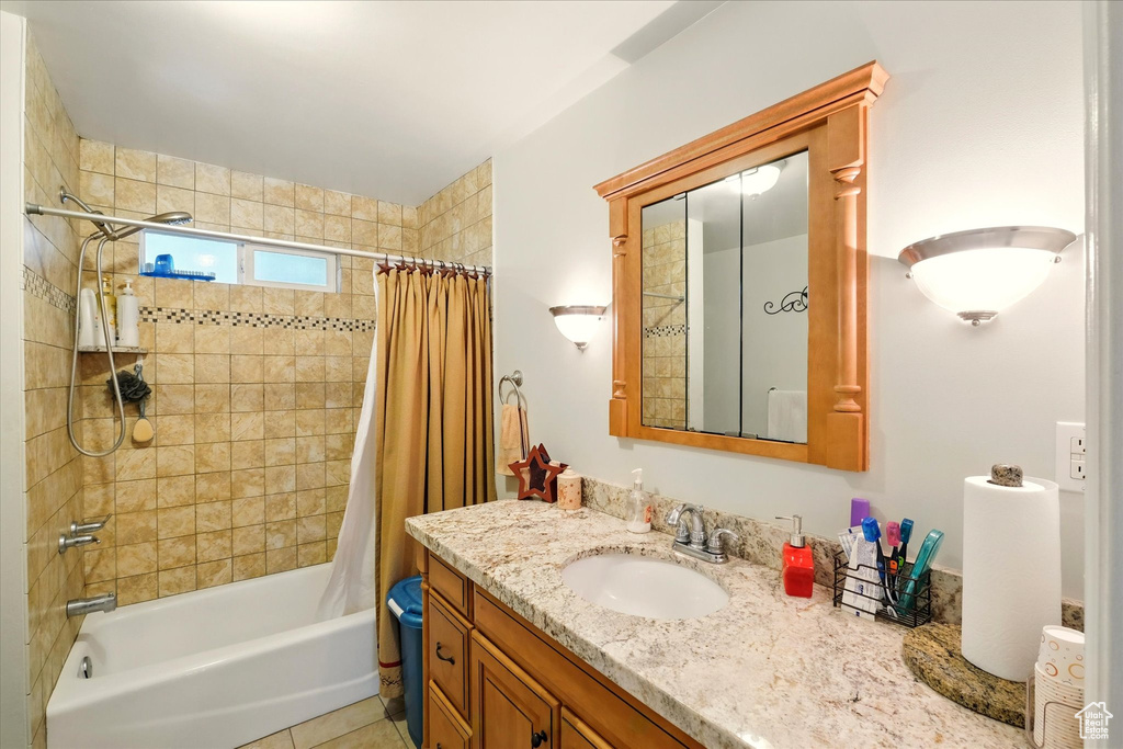 Bathroom with shower / bath combo with shower curtain and vanity