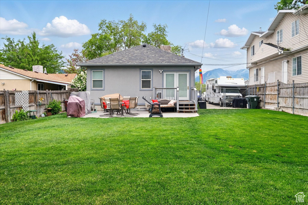 Rear view of property with roof with shingles, a patio area, and stucco siding