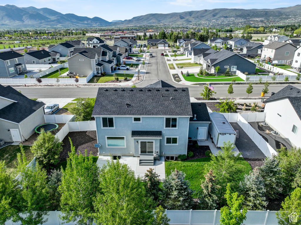 Aerial view of residential area featuring a mountain backdrop
