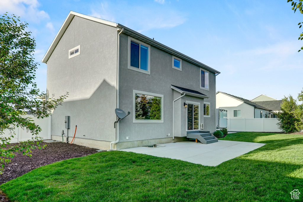 Back of property with a patio area and stucco siding