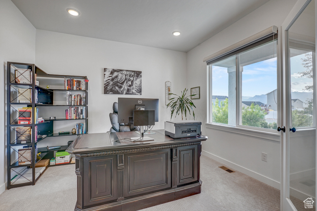 Office space featuring light carpet, baseboards, and recessed lighting