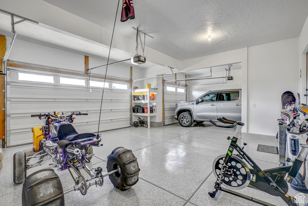Garage featuring a garage door opener