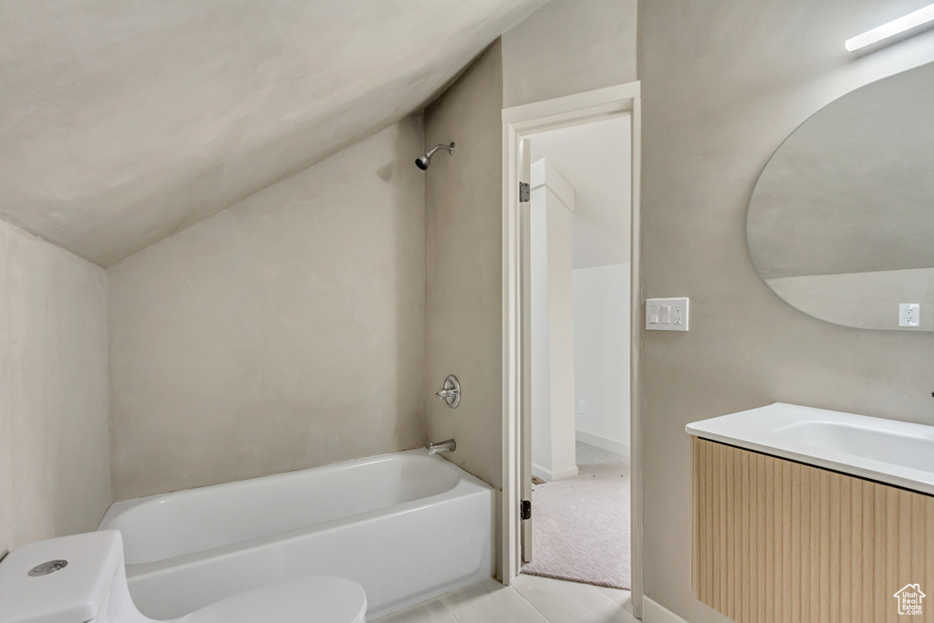 Full bath featuring toilet, vaulted ceiling, bathtub / shower combination, and vanity