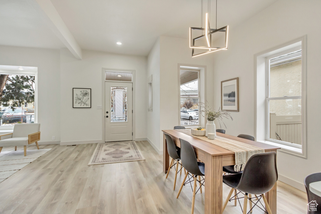 Dining space with healthy amount of natural light, light wood-style flooring, baseboards, and recessed lighting