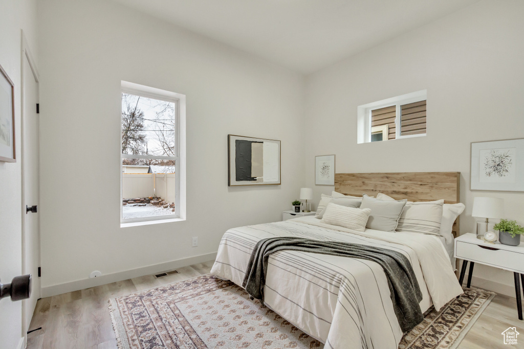 Bedroom with light wood-style floors and baseboards
